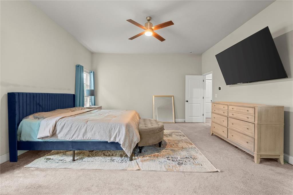 4940 Longview Run Decatur, GA 30035 - Photo 11 of 21 a spacious bedroom with a bed and a flat screen tv