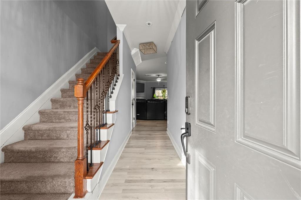 4940 Longview Run Decatur, GA 30035 - Photo 2 of 21 a view of a hallway to a livingroom with wooden floor and stairs