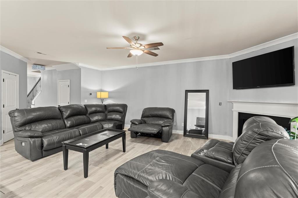 4940 Longview Run Decatur, GA 30035 - Photo 9 of 21 a living room with furniture a flat screen tv and a fireplace