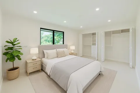 a bedroom with a bed and a potted plant