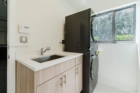 a kitchen with a sink and a refrigerator