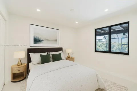 a bedroom with a bed and glass window