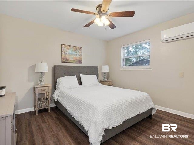 4650 Wiggins Lane Wilmer, AL 36587 - Photo 21 of 66 Bedroom with dark wood-style floors, a ceiling fan, and a wall mounted air conditioner