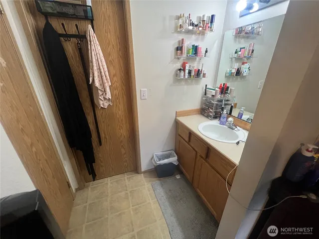 a bathroom with a sink vanity and mirror