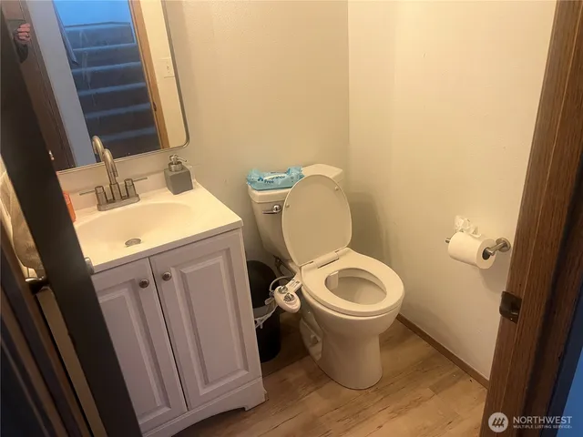 a white toilet sitting next to a sink