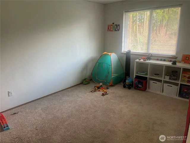 a view of a livingroom with furniture and windows
