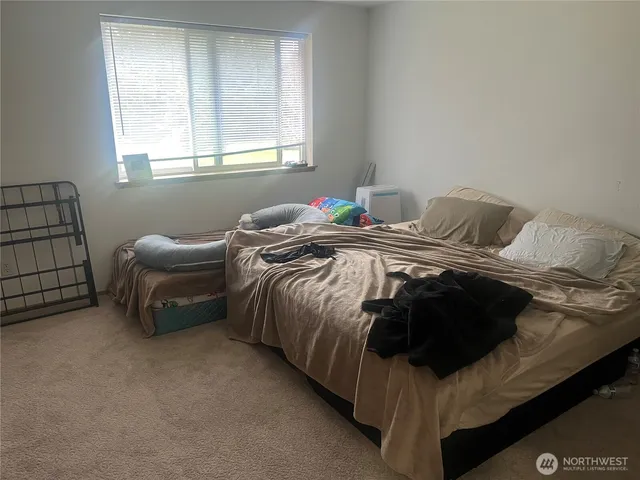 a bedroom with a bed and a window