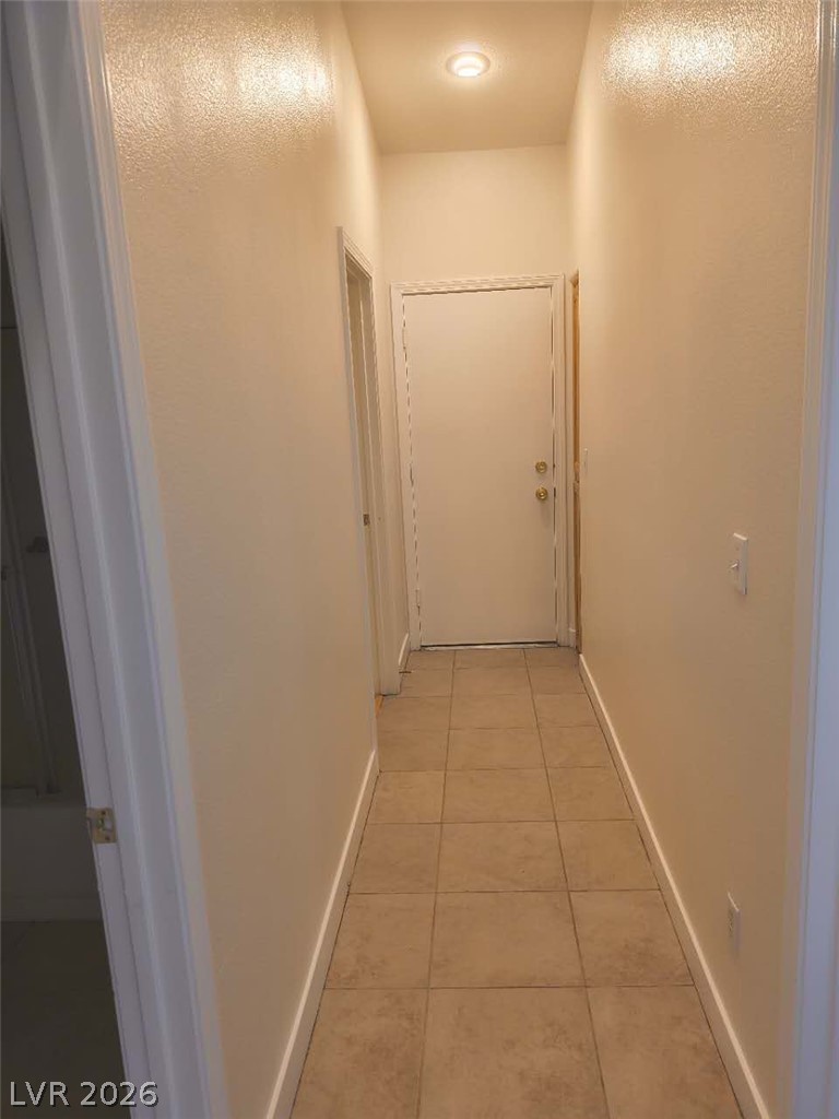 9725 Pima Point Avenue Las Vegas, NV 89147 - Photo 20 of 35 A well-lit corridor featuring durable tile flooring.