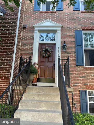 a man walking down a street next to a building
