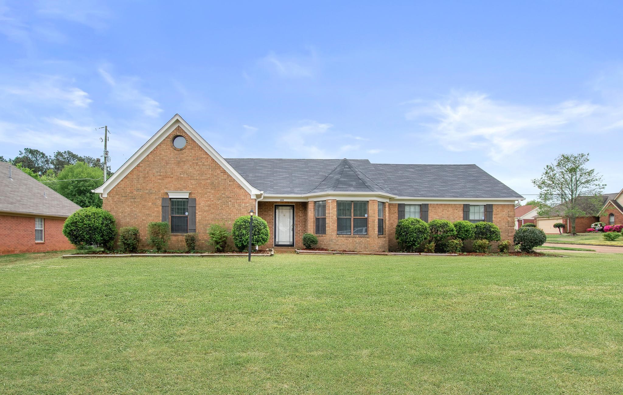 6909 Finch Road Memphis, TN 38141 - Photo 1 of 20 front view of a house next to a yard