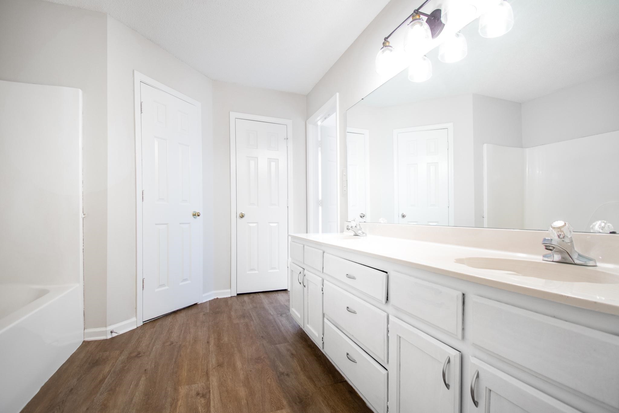 6909 Finch Road Memphis, TN 38141 - Photo 11 of 20 a spacious bathroom with 2 sink and a mirror