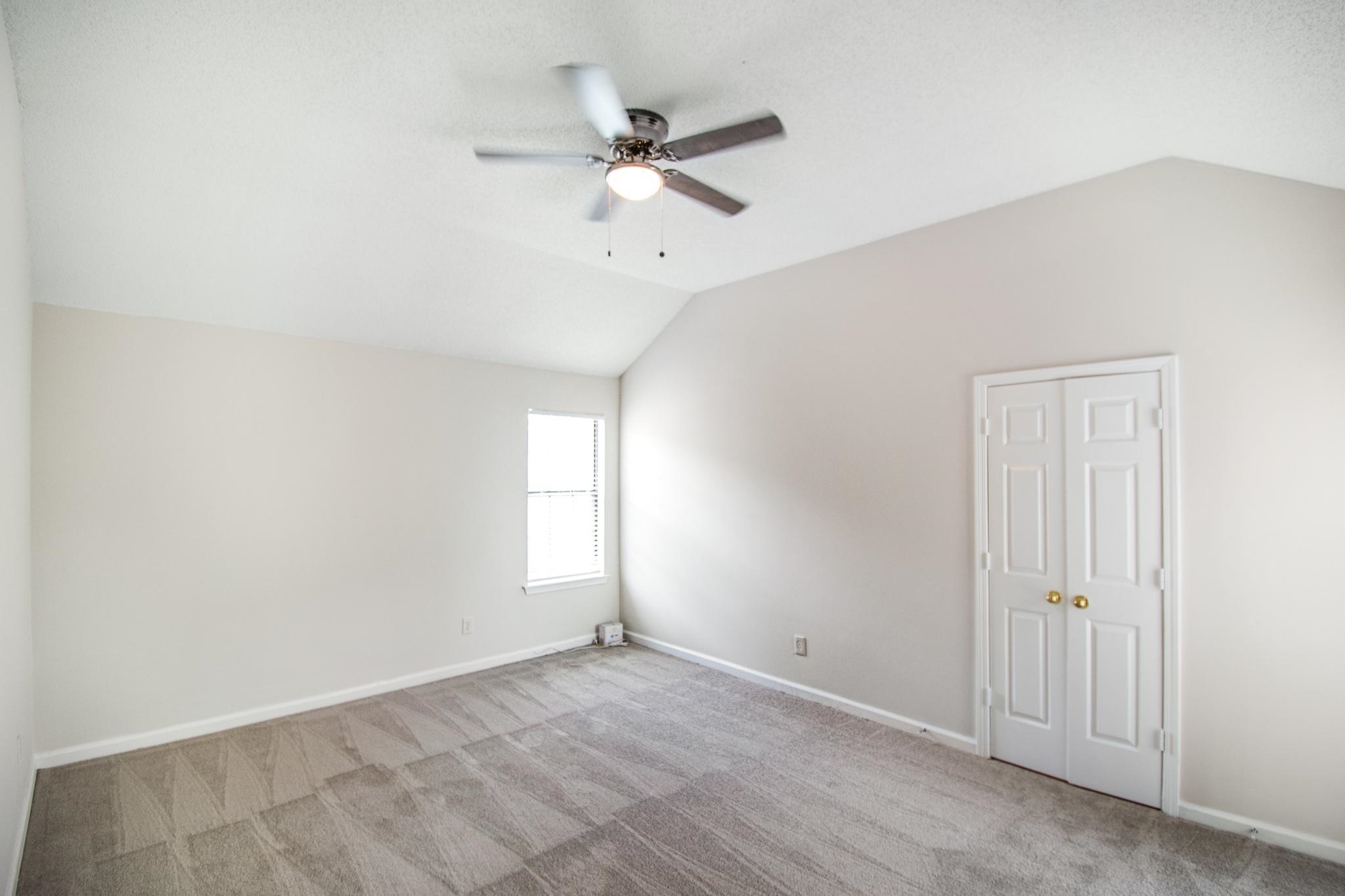 6909 Finch Road Memphis, TN 38141 - Photo 20 of 20 an empty room with a window and a fan