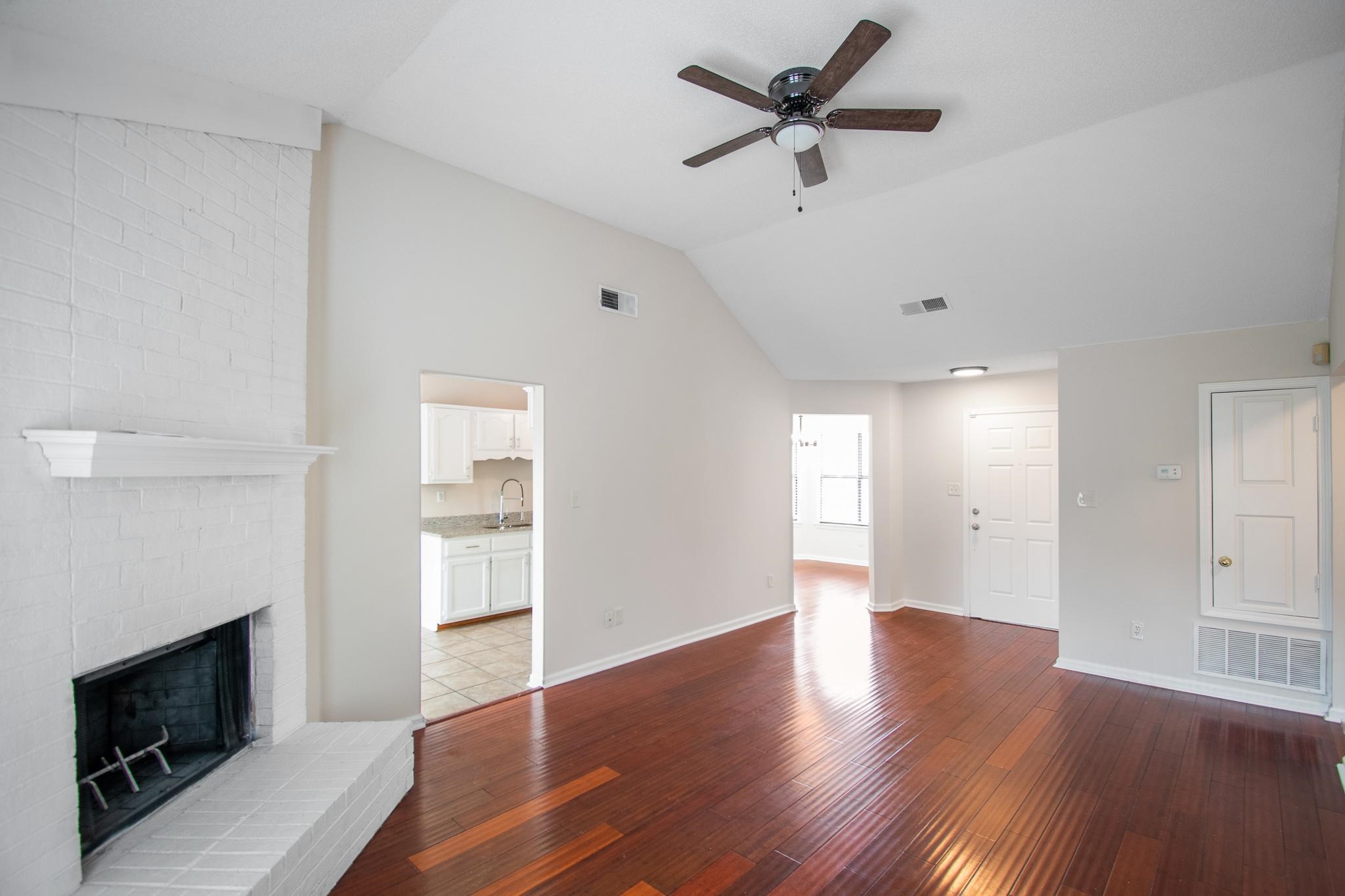6909 Finch Road Memphis, TN 38141 - Photo 5 of 20 a view of an empty room with a fireplace and a window