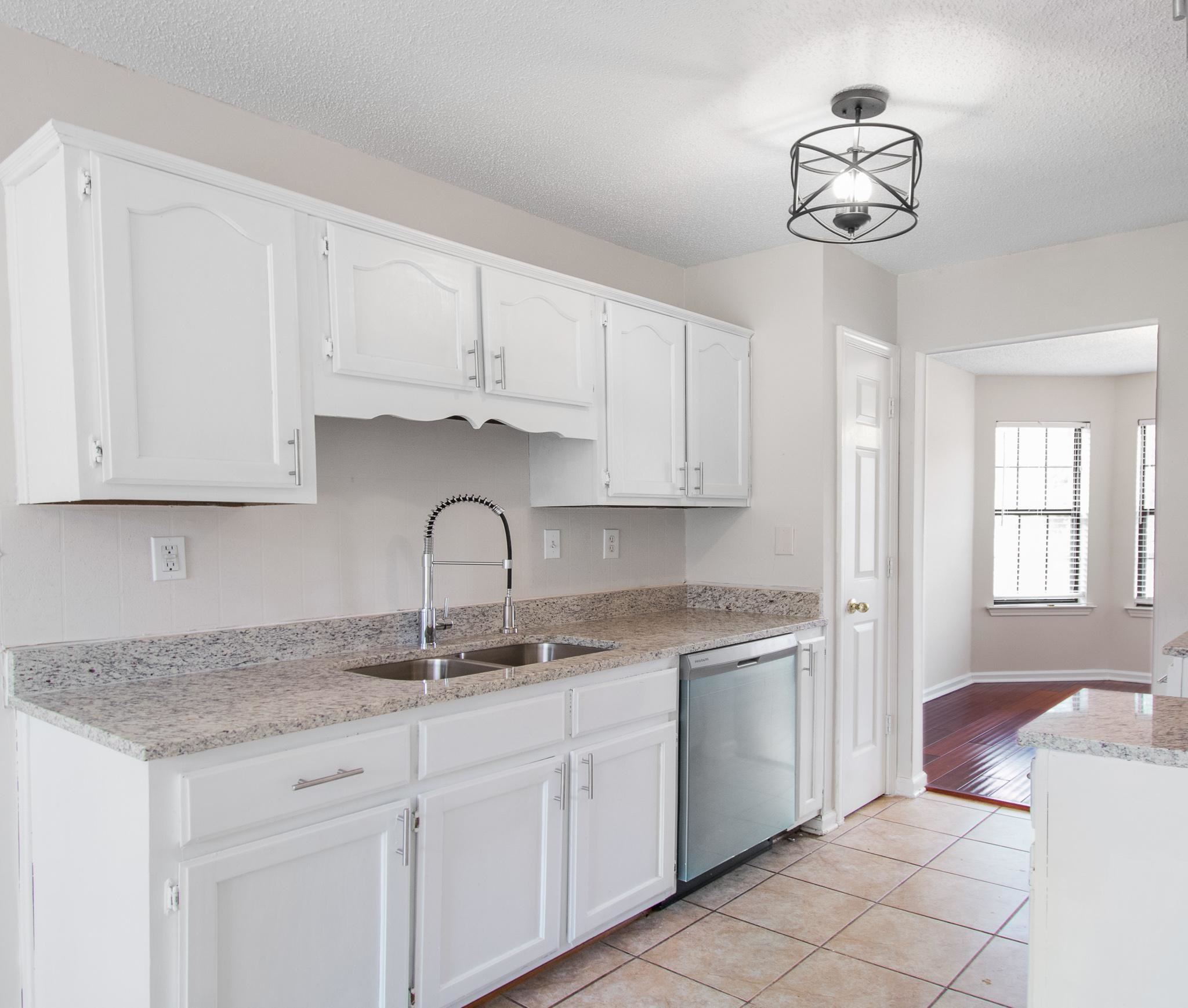 6909 Finch Road Memphis, TN 38141 - Photo 7 of 20 a kitchen with stainless steel appliances granite countertop a sink dishwasher a stove and a microwave oven