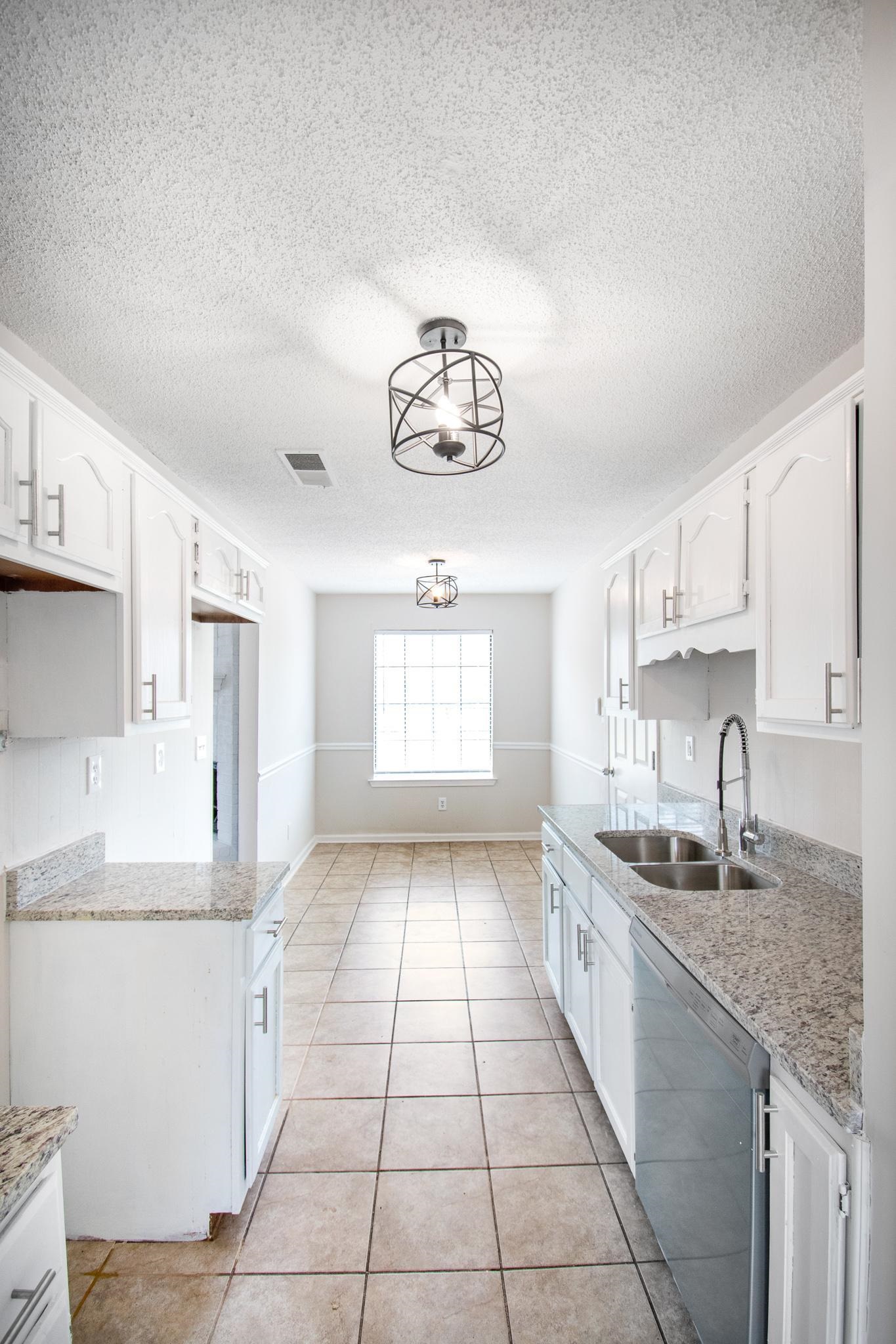 6909 Finch Road Memphis, TN 38141 - Photo 8 of 20 a kitchen with a sink cabinets and window