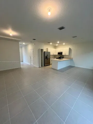 a large kitchen with a large counter top appliances and cabinets