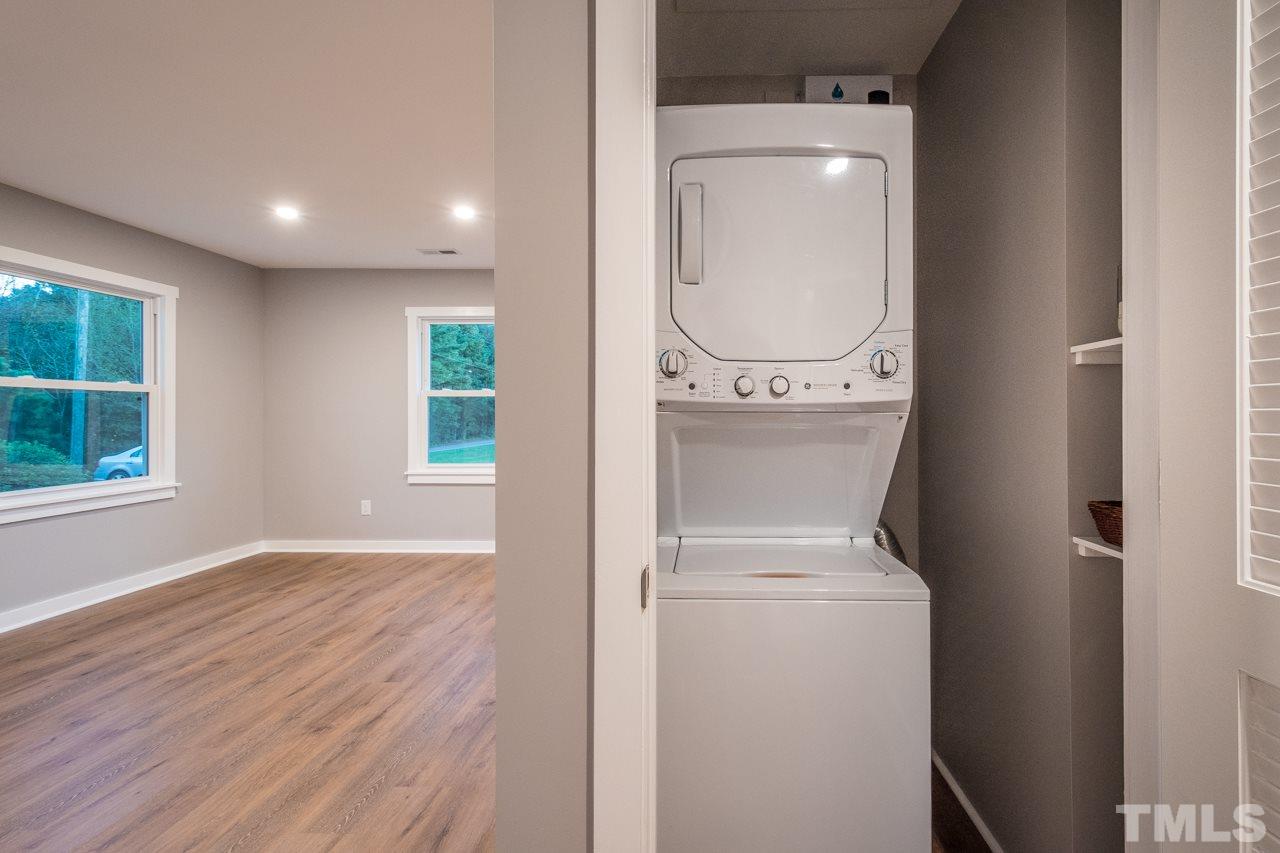 166 Hannah Creek Road Four Oaks, NC 27524 - Photo 9 of 20 a view of a hallway with washer and dryer