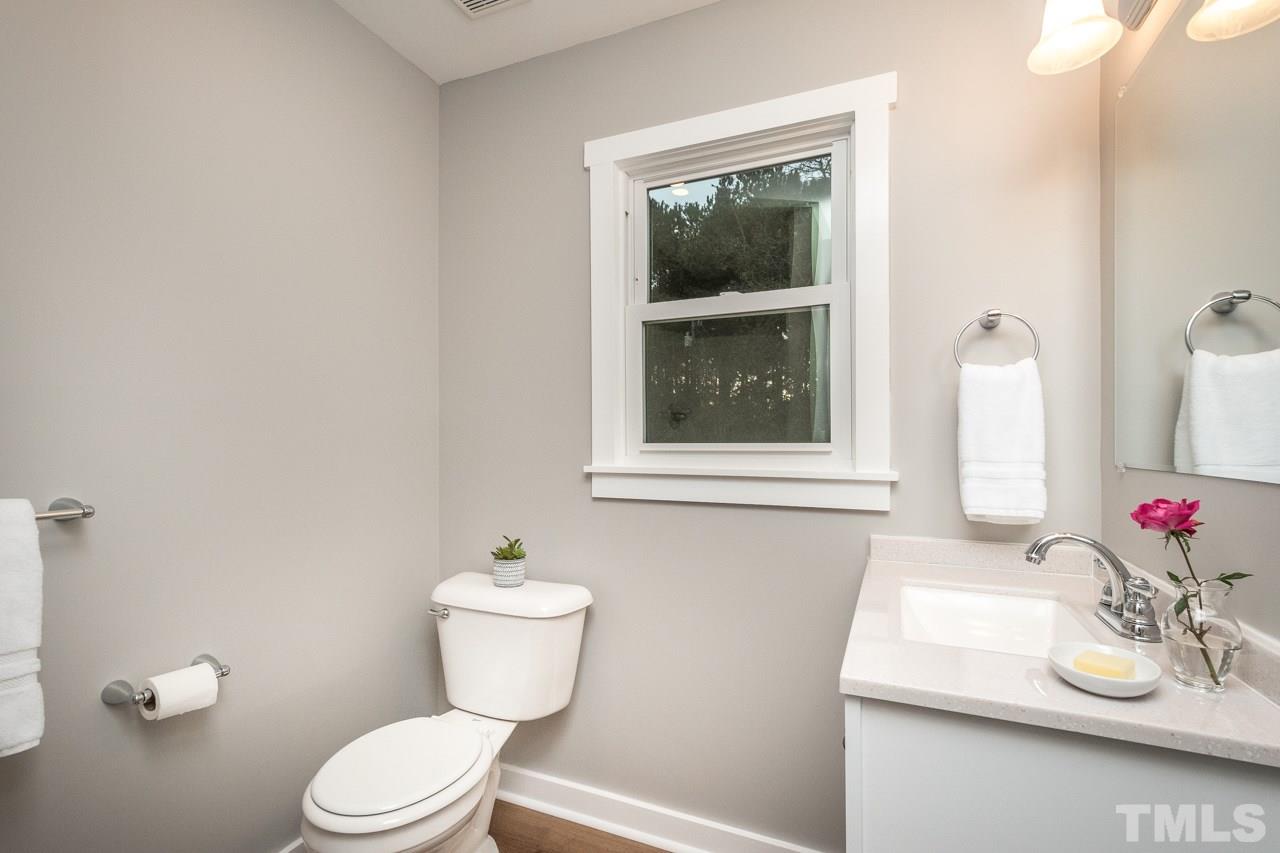 166 Hannah Creek Road Four Oaks, NC 27524 - Photo 10 of 20 a bathroom with a toilet sink and mirror