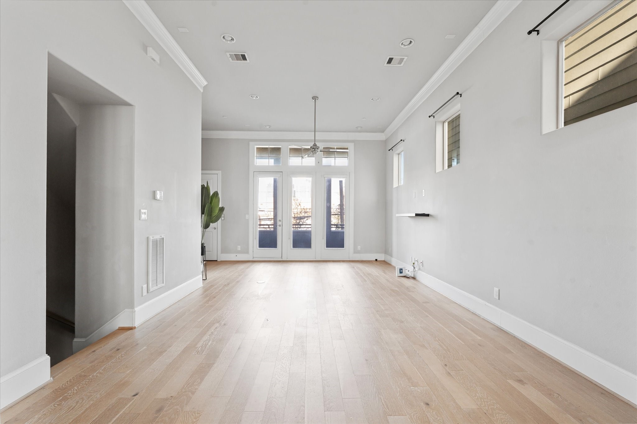 1005 St Charles Street Houston, TX 77003 - Photo 15 of 27 a view of an empty room with wooden floor and a window