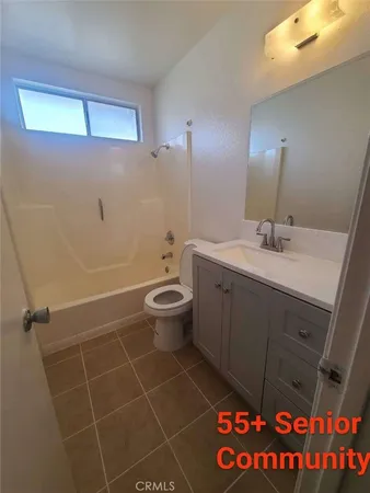 a bathroom with a sink mirror vanity and toilet