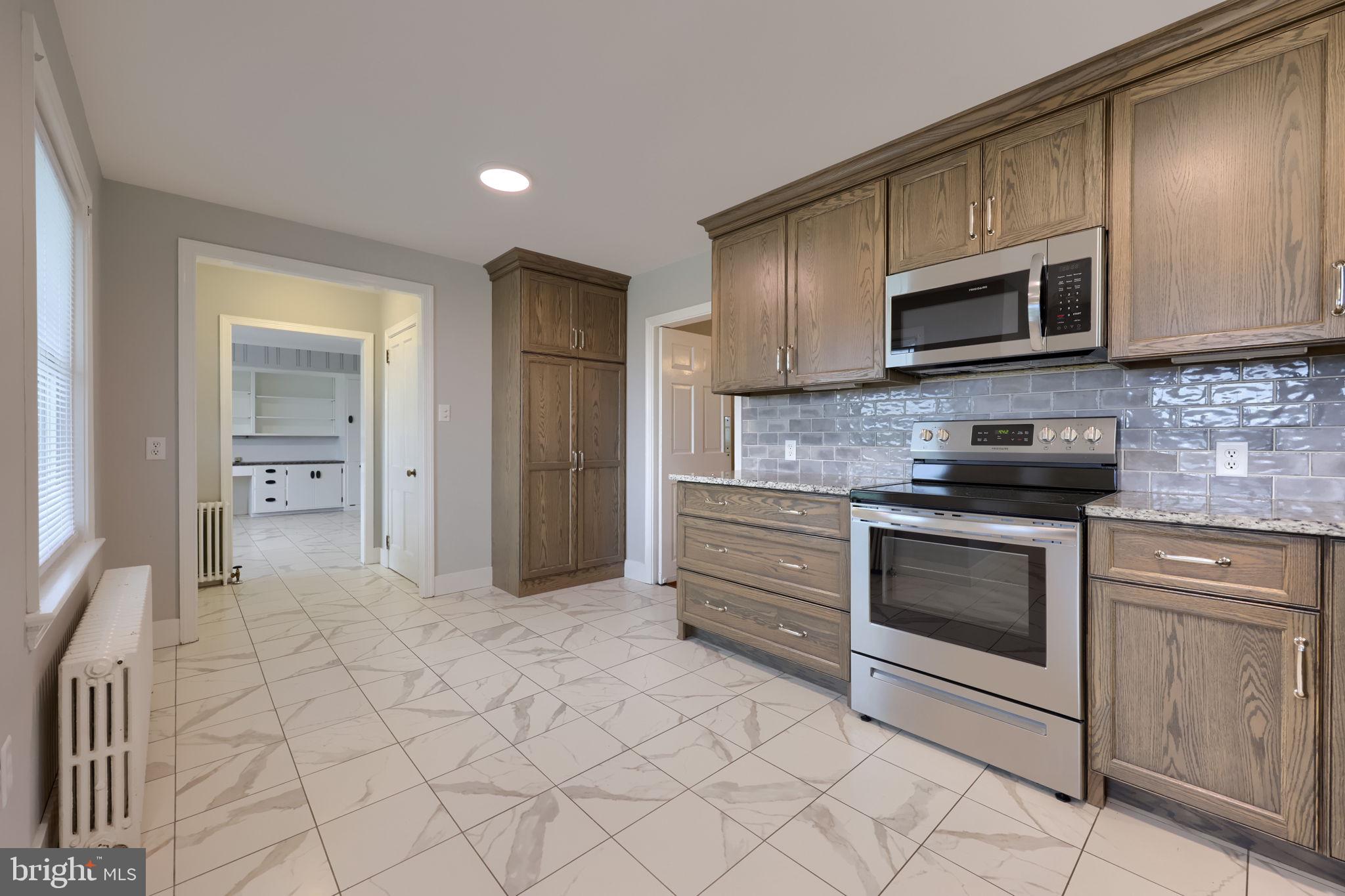 145 Weaver Road Lancaster, PA 17603 - Photo 20 of 87 a kitchen with stainless steel appliances granite countertop a stove a sink and a microwave