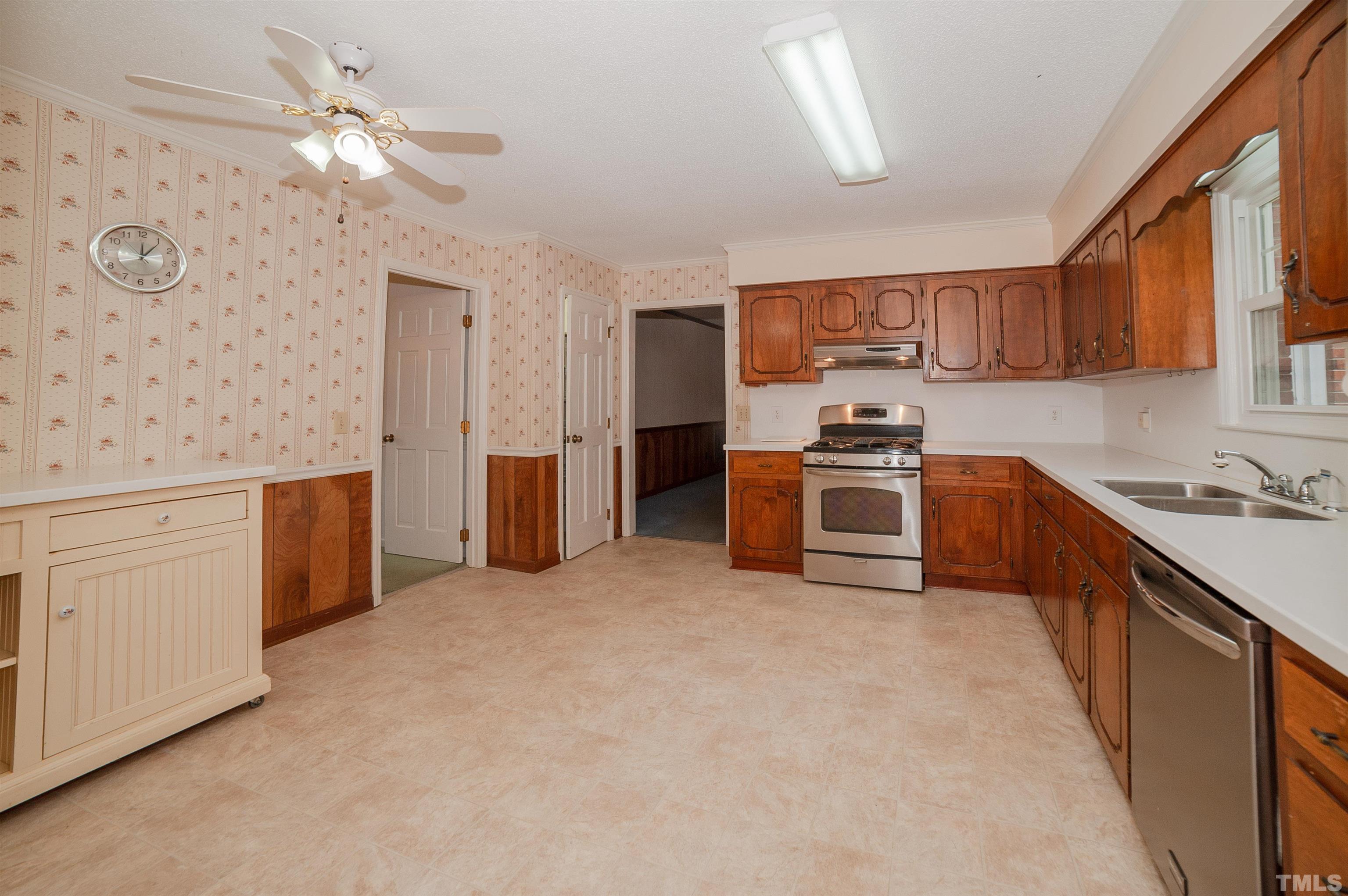6500 King Lawrence Road Raleigh, NC 27607 - Photo 23 of 48 a kitchen with stainless steel appliances a stove sink and cabinets