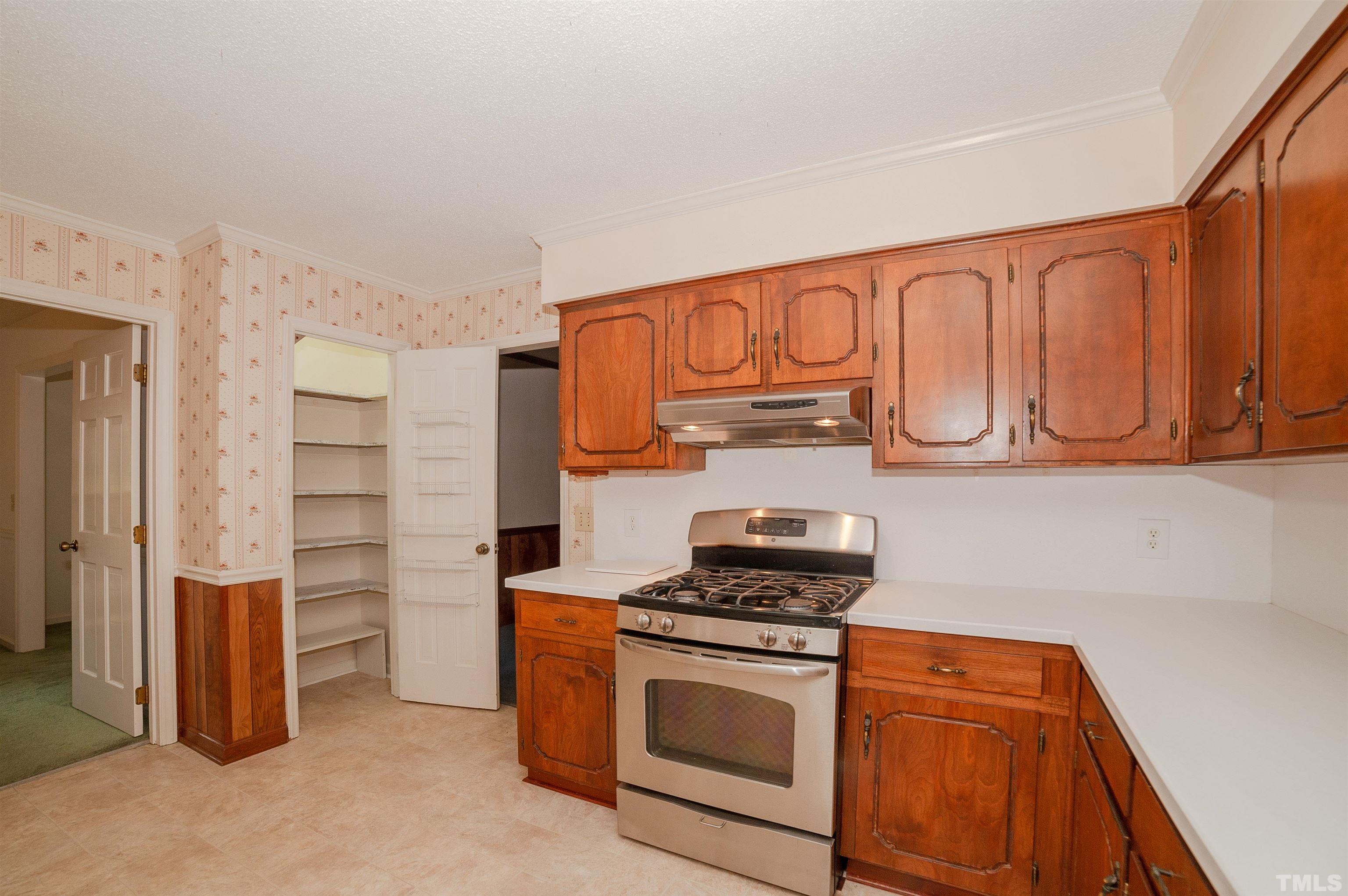 6500 King Lawrence Road Raleigh, NC 27607 - Photo 25 of 48 a kitchen with stainless steel appliances granite countertop a stove and a refrigerator