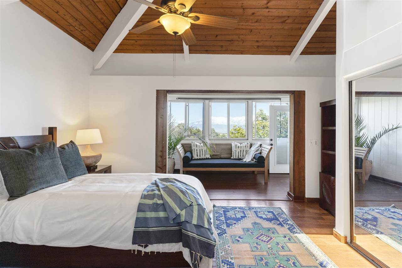 2560 Kokomo Road Haiku, HI 96708 - Photo 18 of 30 a bedroom with a bed and glass door