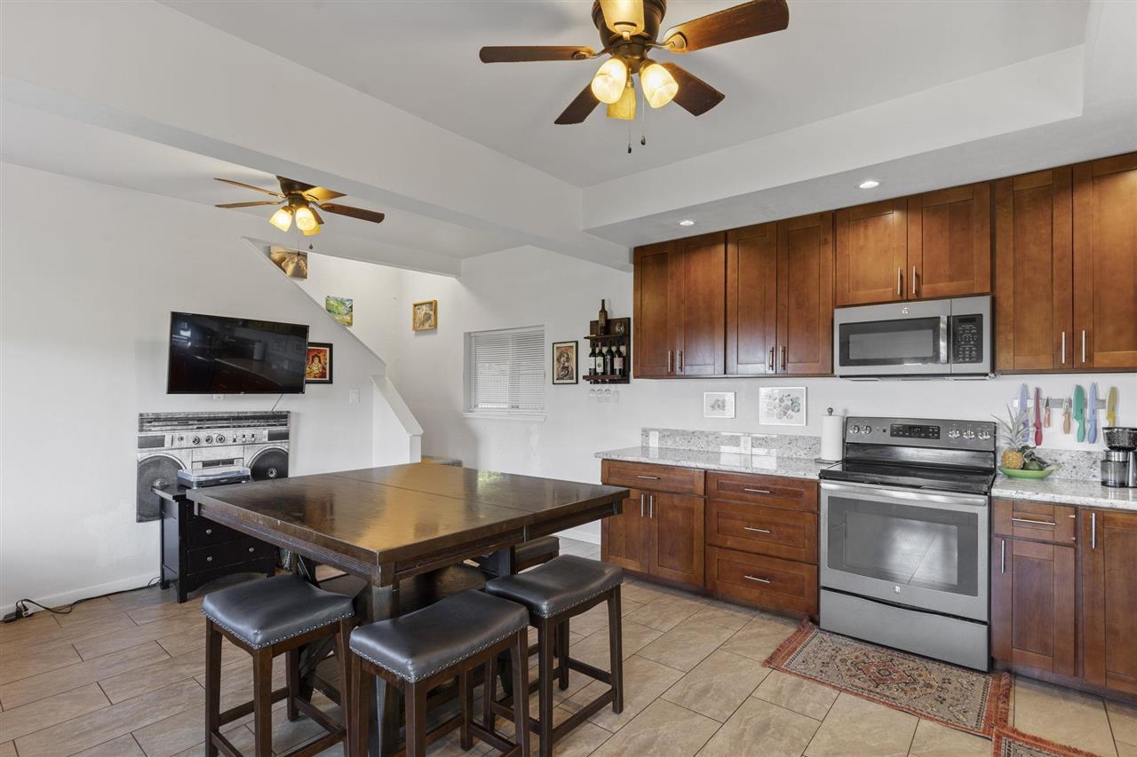 2560 Kokomo Road Haiku, HI 96708 - Photo 9 of 30 a kitchen with a dining table and chairs