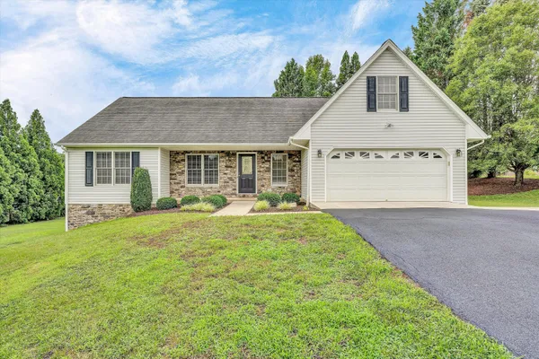 a view of house with yard and entertaining space