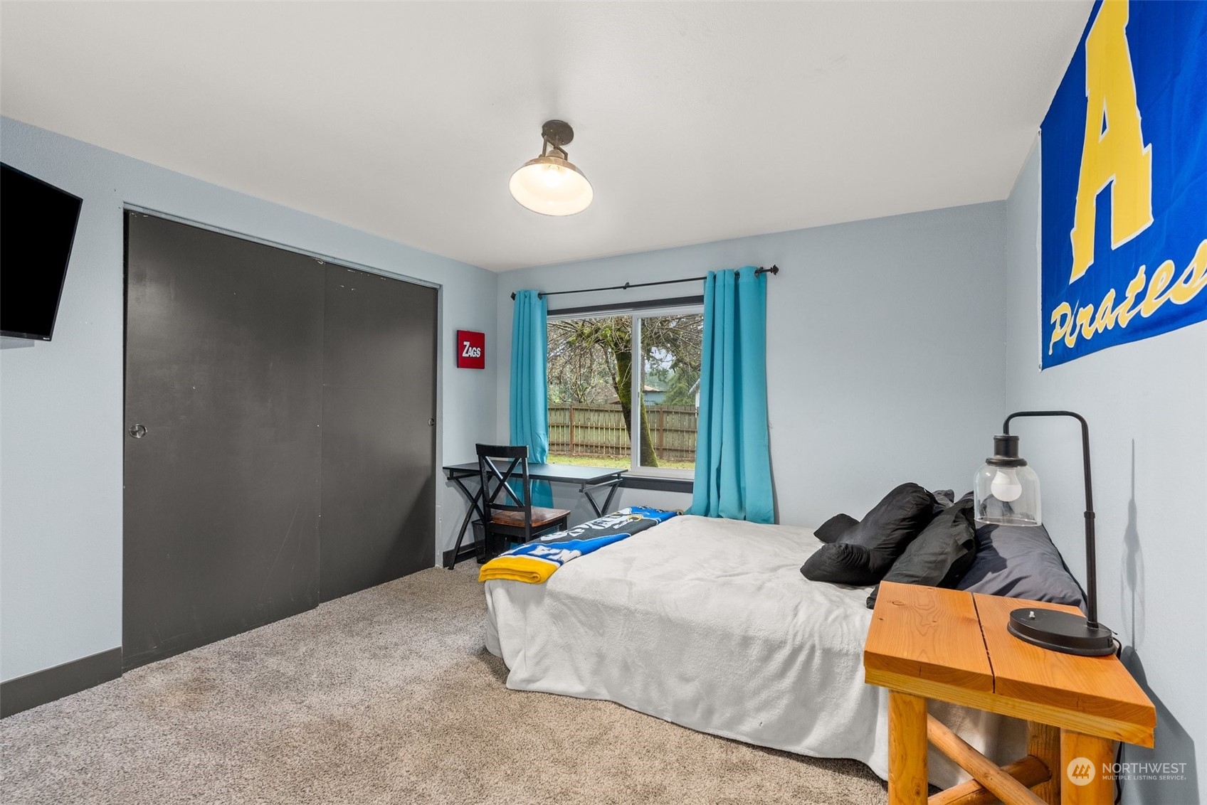 454 Harmon Road, Unit 11 Chehalis, WA 98532 - Photo 17 of 28 a bedroom with a bed and a flat screen tv