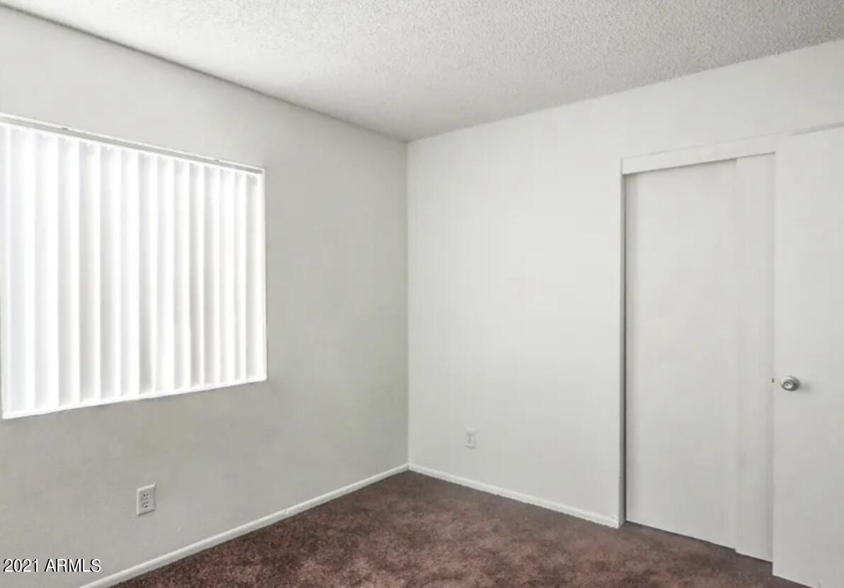 1709 West Mountain View Road, Unit 205 Phoenix, AZ 85021 - Photo 5 of 7 a view of an empty room with a window