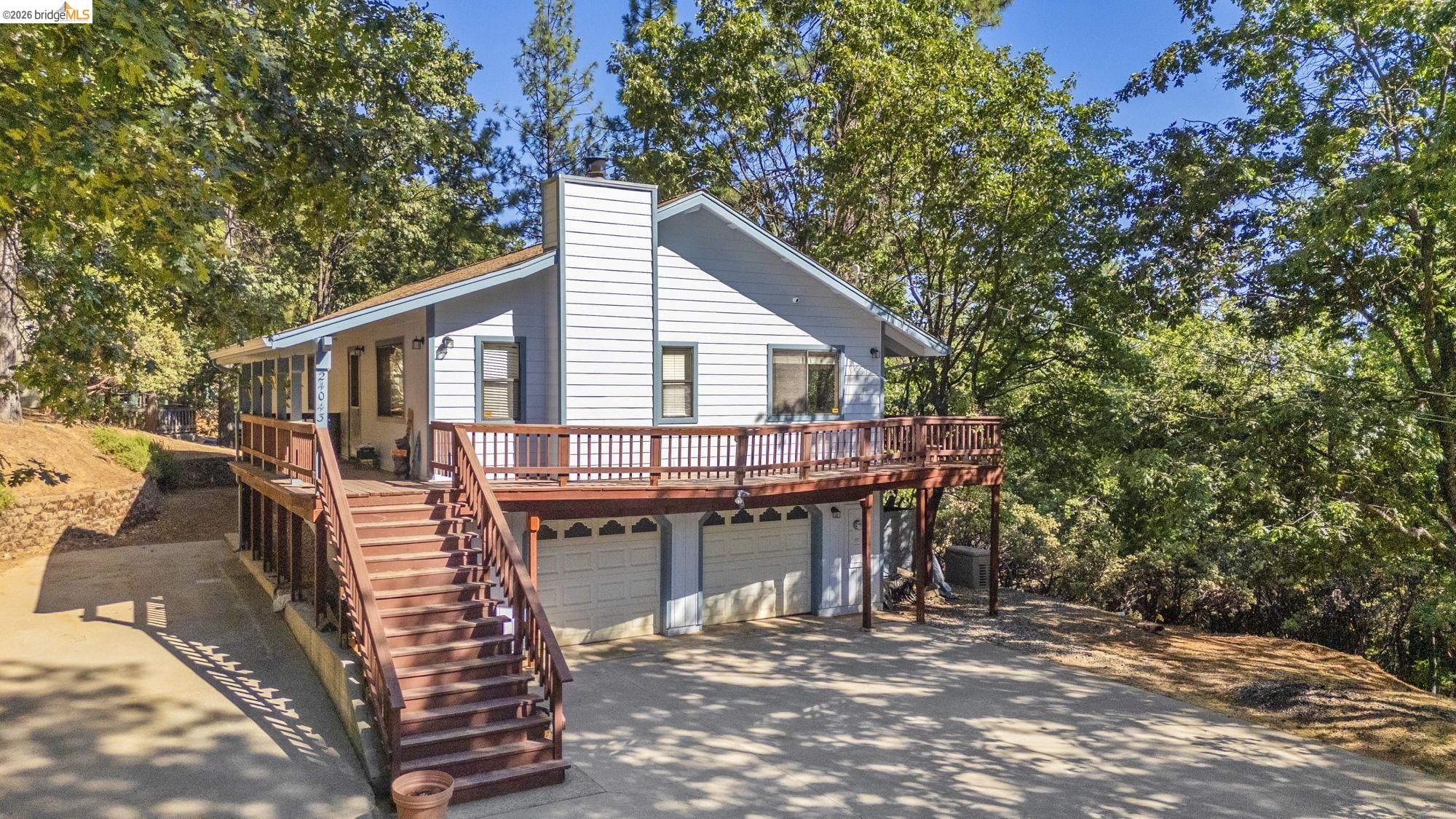 a view of a house with backyard and sitting area