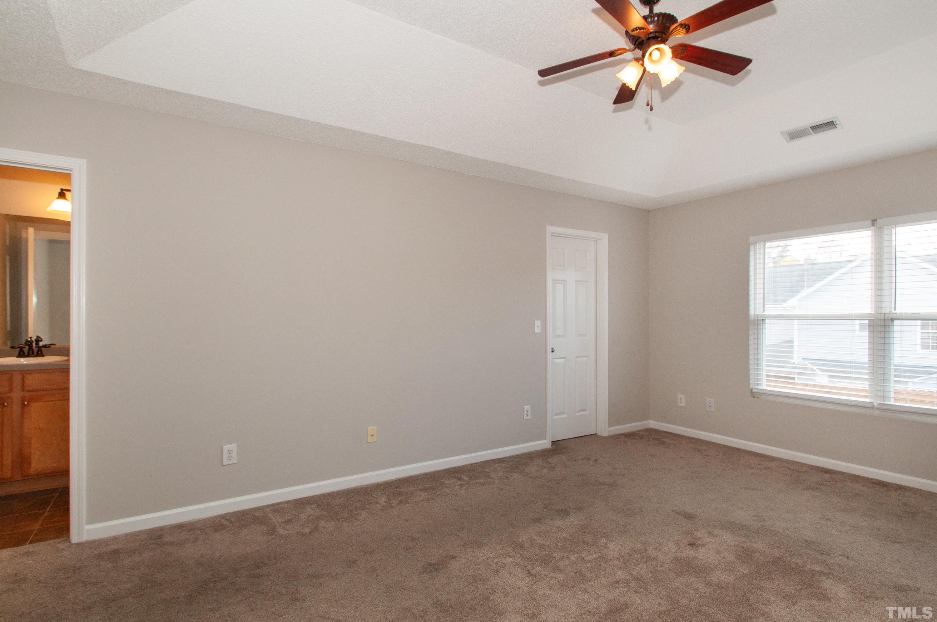 3808 Tryon Ridge Drive Raleigh, NC 27610 - Photo 11 of 30 an empty room with a window and a fan