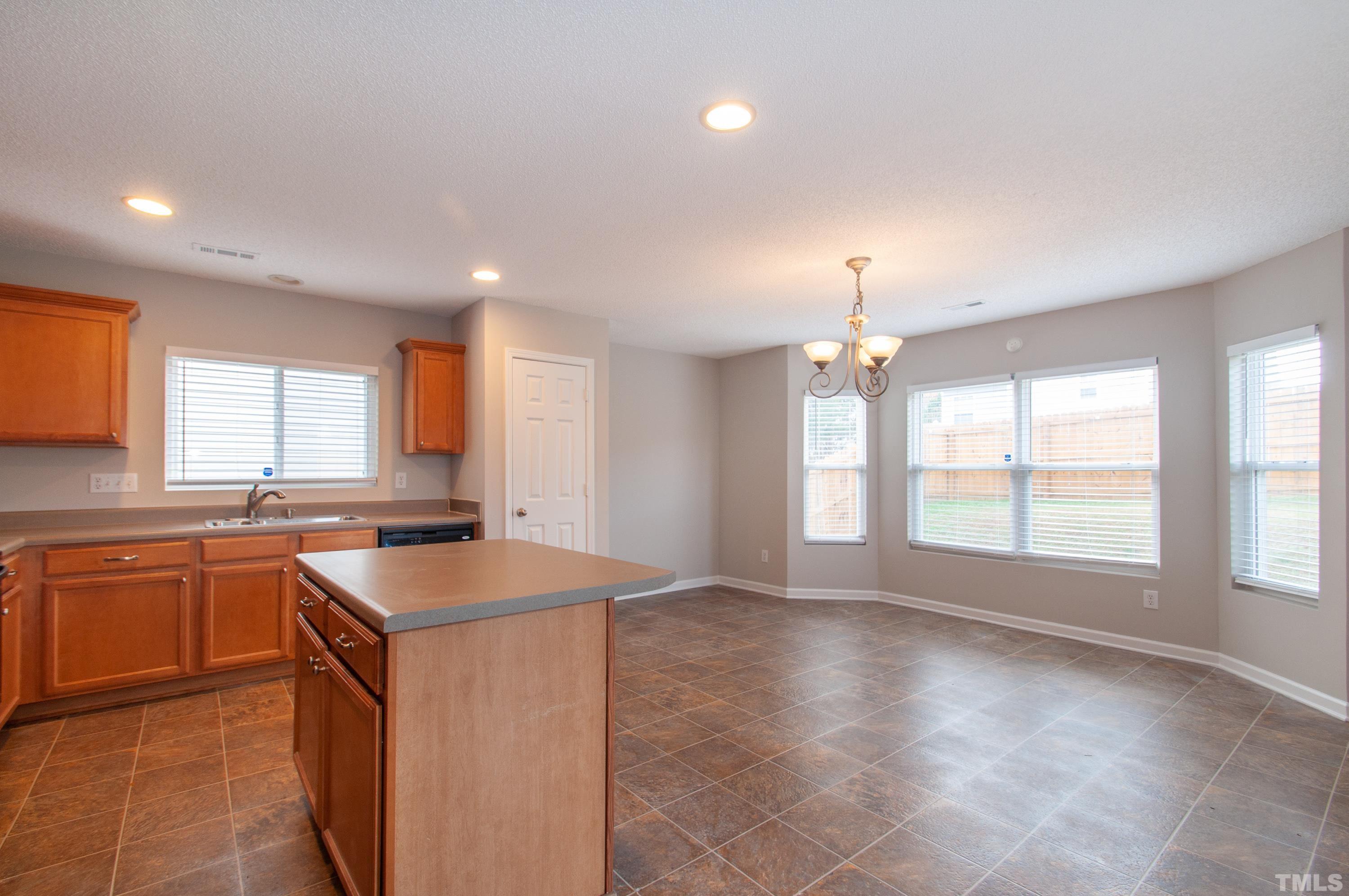 3808 Tryon Ridge Drive Raleigh, NC 27610 - Photo 7 of 30 a kitchen with stainless steel appliances granite countertop a sink and a stove