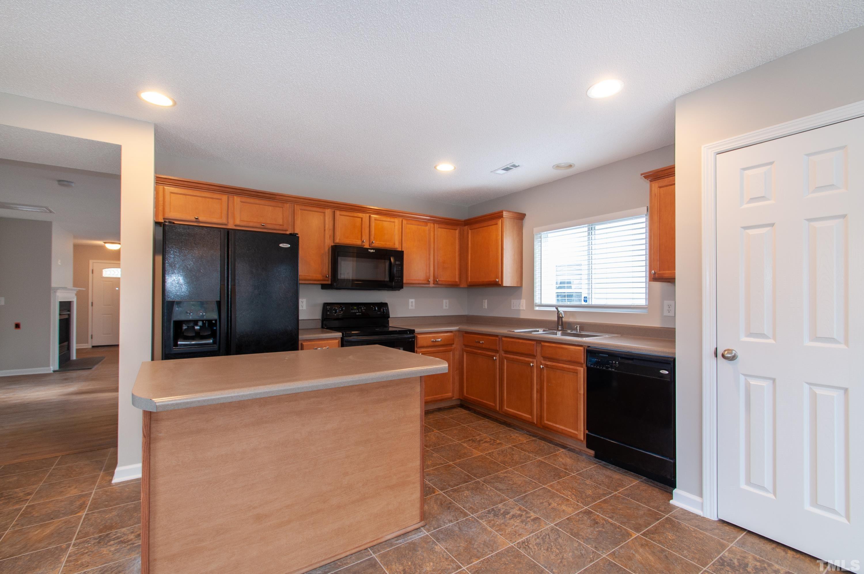 3808 Tryon Ridge Drive Raleigh, NC 27610 - Photo 8 of 30 a large kitchen with stainless steel appliances kitchen island granite countertop a refrigerator a sink a stove and dishwasher