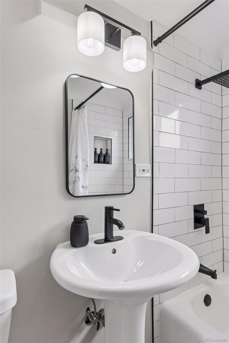 2255 Meade Street Denver, CO 80211 - Photo 17 of 30 a bathroom with a sink a toilet and mirror