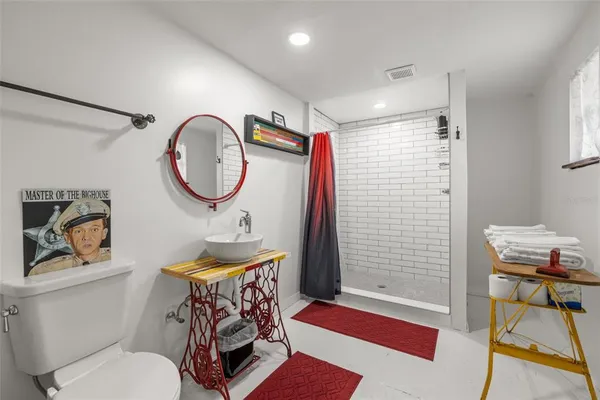 a bathroom with a sink vanity mirror and toilet