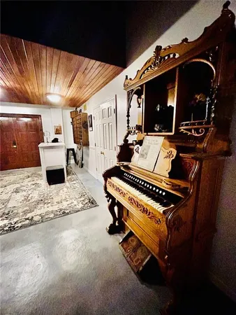 a kitchen with refrigerator and chairs