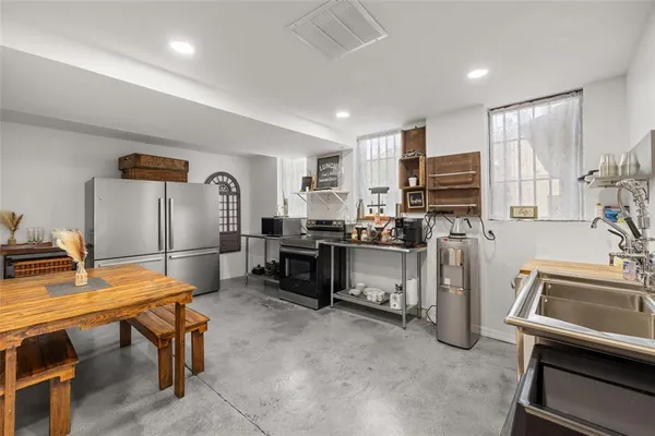 a kitchen with stainless steel appliances a stove a sink and a refrigerator