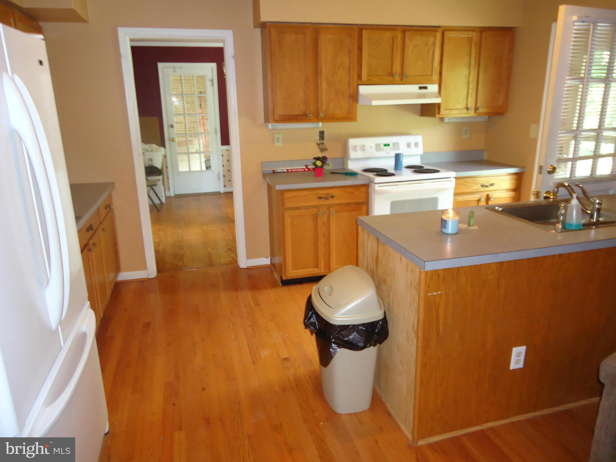 17411 Conoy Road Barnesville, MD 20838 - Photo 3 of 17 a kitchen with a sink a stove cabinets and a dining table