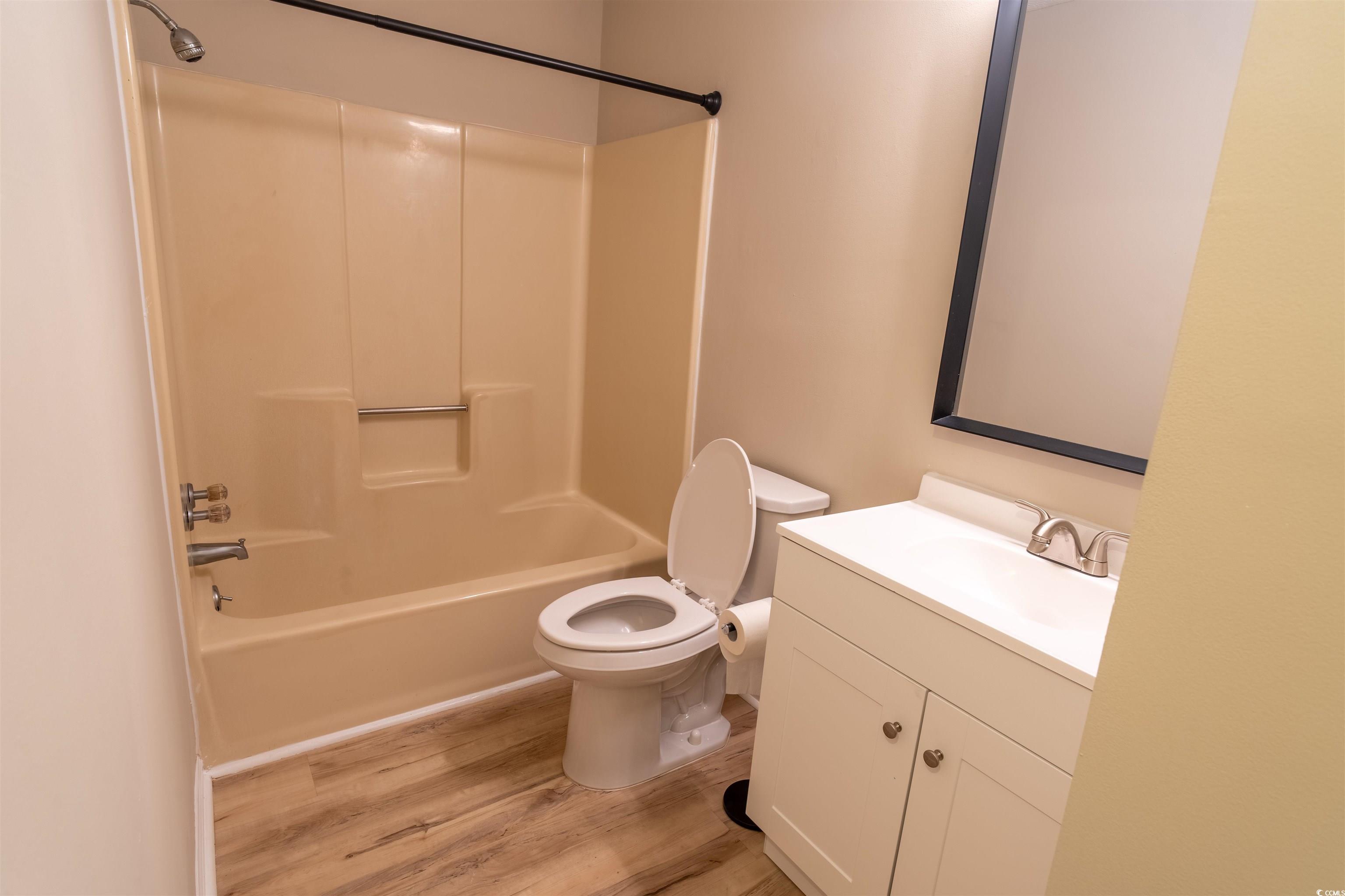 4708 Cobblestone Drive, Unit I8 Myrtle Beach, SC 29577 - Photo 11 of 15 Bathroom with vanity, shower / bathtub combination, and light wood-style floors
