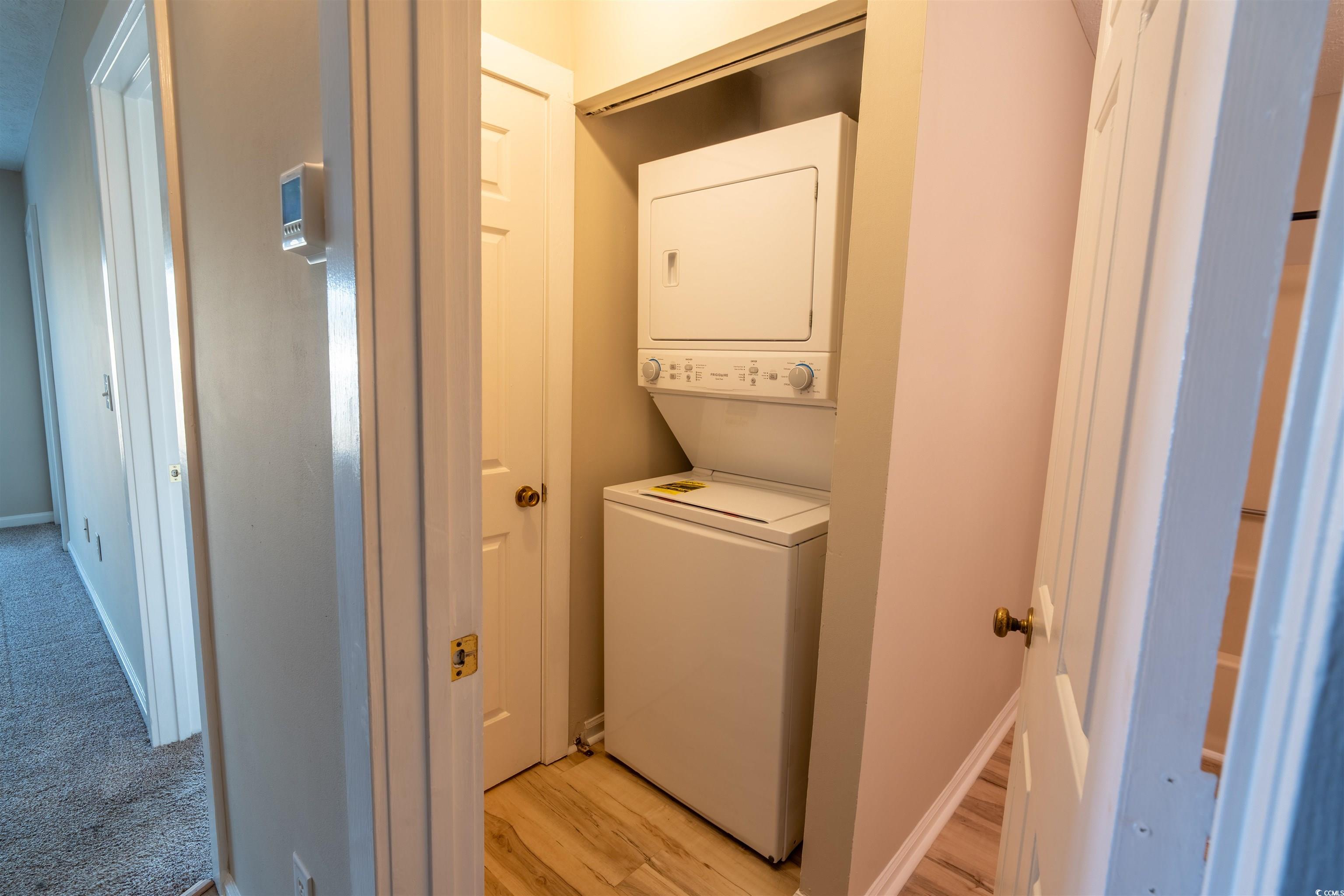 4708 Cobblestone Drive, Unit I8 Myrtle Beach, SC 29577 - Photo 12 of 15 Laundry area featuring light wood finished floors and stacked washer / drying machine