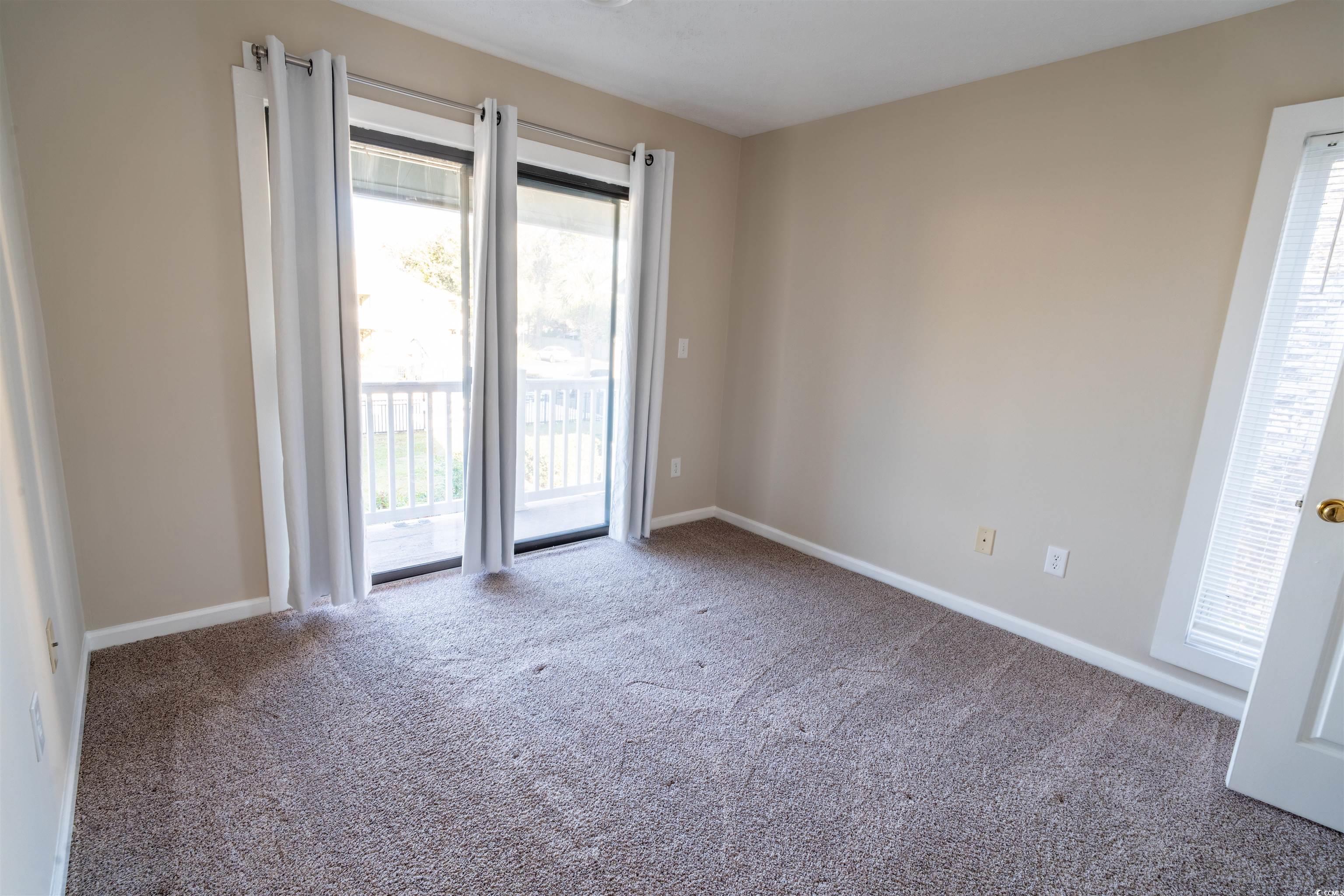 4708 Cobblestone Drive, Unit I8 Myrtle Beach, SC 29577 - Photo 8 of 15 Spare room featuring carpet and baseboards