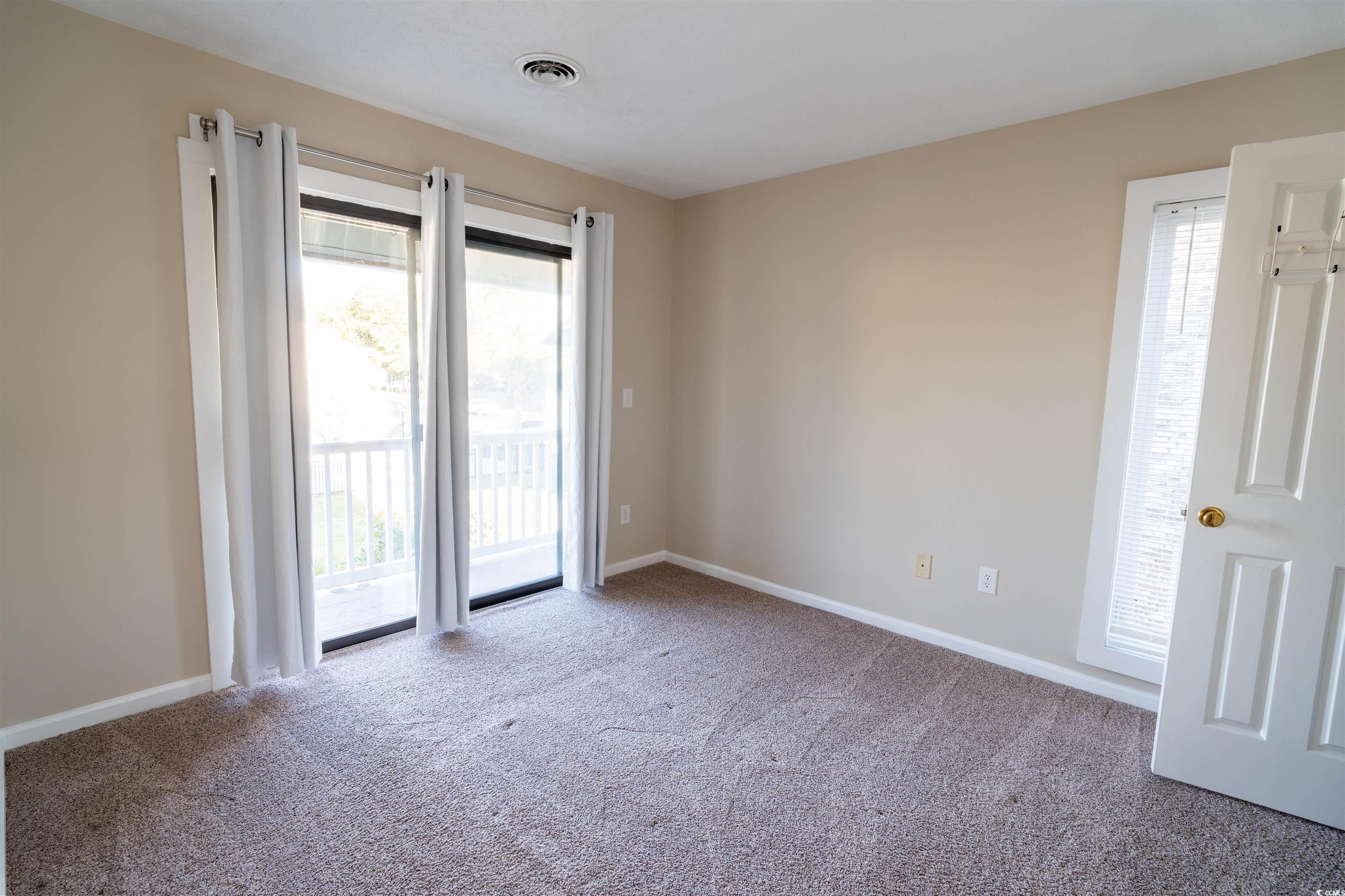 4708 Cobblestone Drive, Unit I8 Myrtle Beach, SC 29577 - Photo 9 of 15 Spare room featuring light colored carpet and plenty of natural light