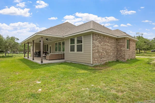 a view of a patio with table and chairs and potted plants
