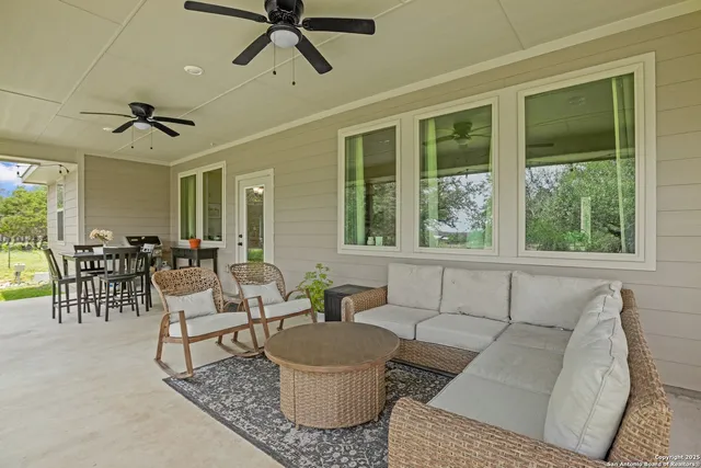 a living room with fireplace furniture and a large window