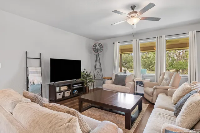 a living room with furniture and kitchen view