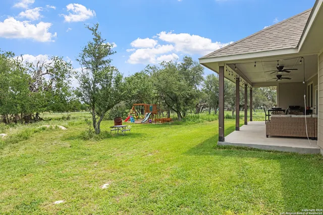 a view of a house with a backyard