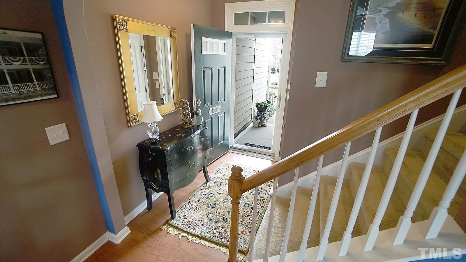 10115 Barnhart Way Raleigh, NC 27617 - Photo 11 of 60 a view of staircase with lots of frames on wall and a window